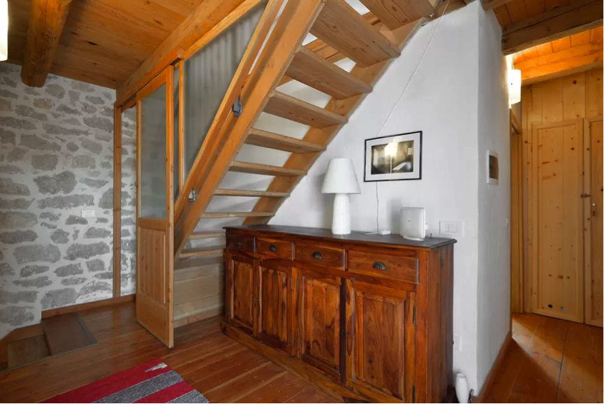 This is the hallway of the middle floor. The stairs lead up to the master bedroom. To the right is the bathroom and library.